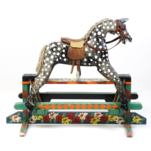 6 - Toy: A 20thC carved wooden rocking horse with hand painted decoration by Norman Dibben of Amersham, ... 