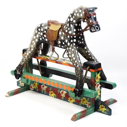 6 - Toy: A 20thC carved wooden rocking horse with hand painted decoration by Norman Dibben of Amersham, ... 