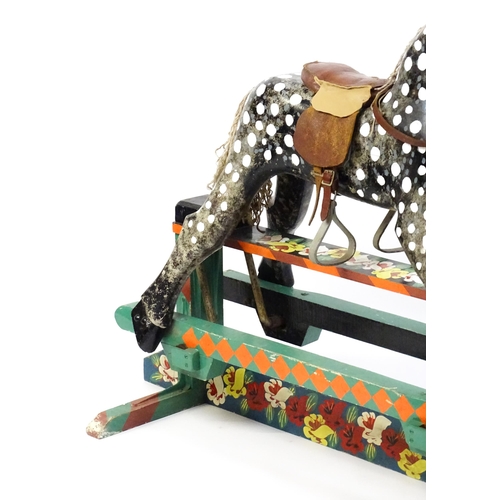 6 - Toy: A 20thC carved wooden rocking horse with hand painted decoration by Norman Dibben of Amersham, ... 