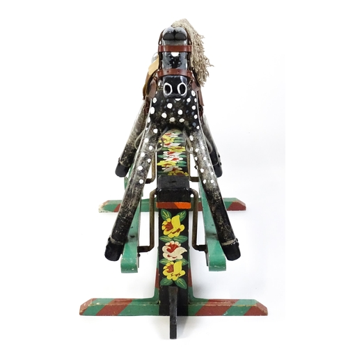 6 - Toy: A 20thC carved wooden rocking horse with hand painted decoration by Norman Dibben of Amersham, ... 