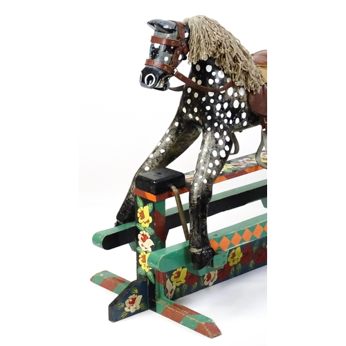 6 - Toy: A 20thC carved wooden rocking horse with hand painted decoration by Norman Dibben of Amersham, ... 