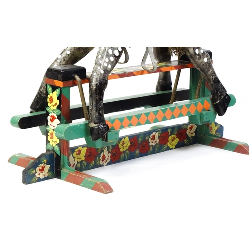 6 - Toy: A 20thC carved wooden rocking horse with hand painted decoration by Norman Dibben of Amersham, ... 