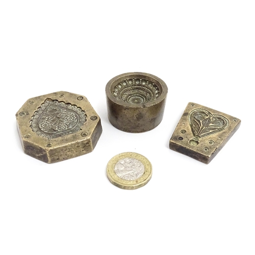 380 - Three Indian cast bronze jeweller's moulds, two having floral and foliate detail, and one of roundel... 
