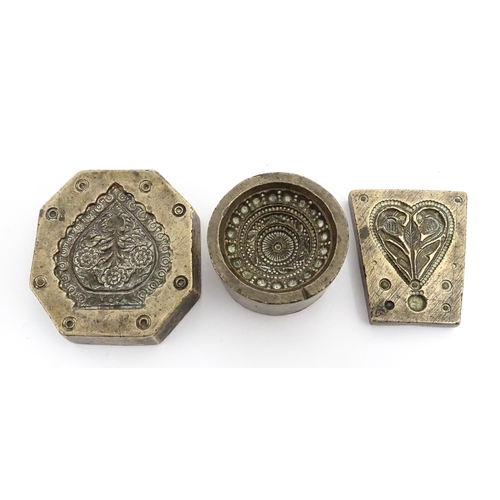 380 - Three Indian cast bronze jeweller's moulds, two having floral and foliate detail, and one of roundel... 
