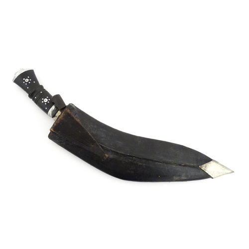 452 - A mid 20thC Indian Kukhri knife with carved horn handle. The leather scabbard with additional chakma... 