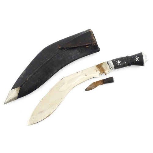 452 - A mid 20thC Indian Kukhri knife with carved horn handle. The leather scabbard with additional chakma... 