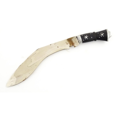 452 - A mid 20thC Indian Kukhri knife with carved horn handle. The leather scabbard with additional chakma... 