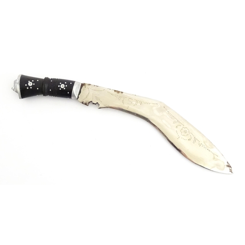 452 - A mid 20thC Indian Kukhri knife with carved horn handle. The leather scabbard with additional chakma... 