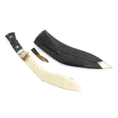 452 - A mid 20thC Indian Kukhri knife with carved horn handle. The leather scabbard with additional chakma... 