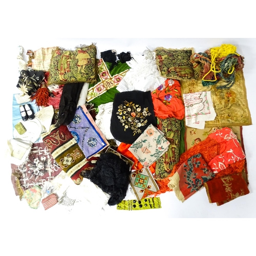 31 - A quantity of assorted textiles to include a 20thC needlework sample with letters of the alphabet by... 