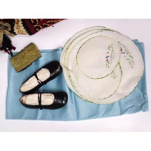 31 - A quantity of assorted textiles to include a 20thC needlework sample with letters of the alphabet by... 