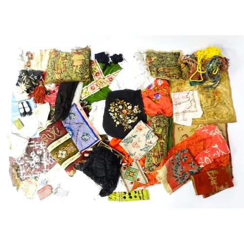 31 - A quantity of assorted textiles to include a 20thC needlework sample with letters of the alphabet by... 