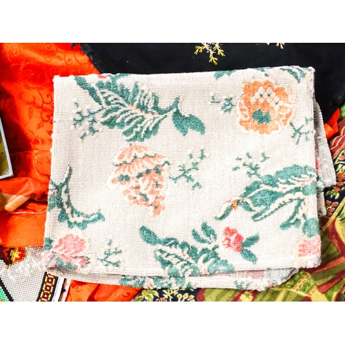 31 - A quantity of assorted textiles to include a 20thC needlework sample with letters of the alphabet by... 