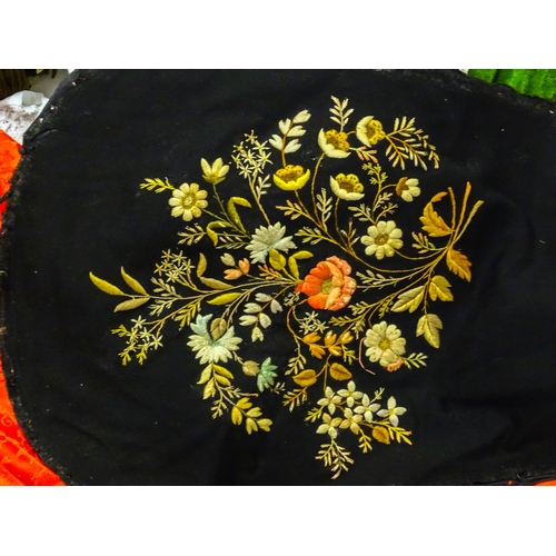 31 - A quantity of assorted textiles to include a 20thC needlework sample with letters of the alphabet by... 