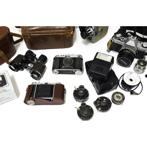 519 - A quantity of assorted film cameras and binoculars to include a Canon AE-1, Sekonic Elmatic 8mm movi... 