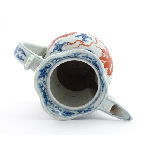 13 - A Chinese blue, white and iron red wine ewer decorated with dragons and stylised clouds. Character m... 