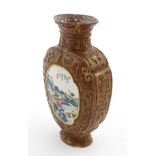 16 - A Chinese famille rose vase with brown ground and gilt highlights, decorated with landscapes and Cha... 