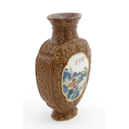 16 - A Chinese famille rose vase with brown ground and gilt highlights, decorated with landscapes and Cha... 