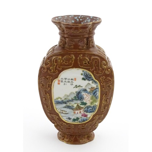 16 - A Chinese famille rose vase with brown ground and gilt highlights, decorated with landscapes and Cha... 