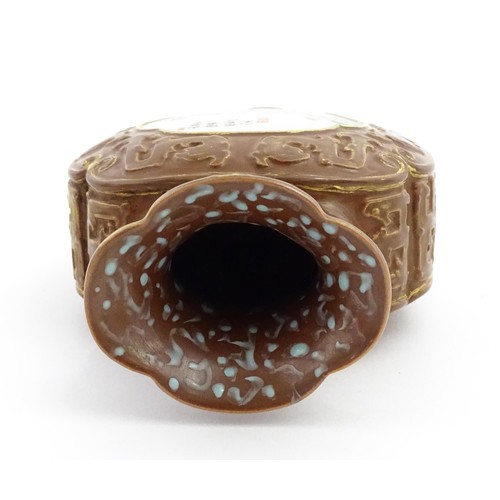 16 - A Chinese famille rose vase with brown ground and gilt highlights, decorated with landscapes and Cha... 