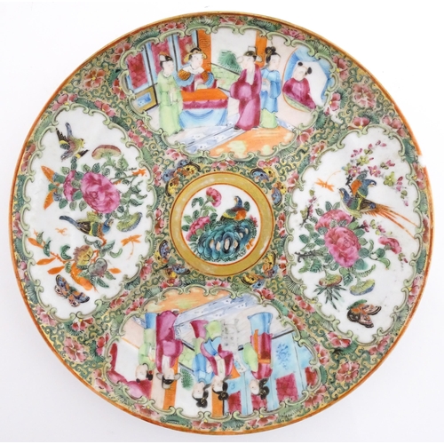 26 - A Chinese / Cantonese famille rose plate decorated with figures, bird, butterflies and flowers. Appr... 
