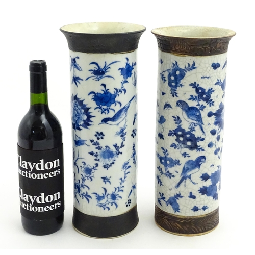 38 - A matched pair of Chinese blue and white vases of cylindrical form, decorated with flowers, birds, i... 