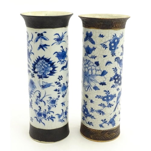 38 - A matched pair of Chinese blue and white vases of cylindrical form, decorated with flowers, birds, i... 