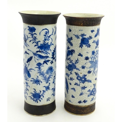 38 - A matched pair of Chinese blue and white vases of cylindrical form, decorated with flowers, birds, i... 