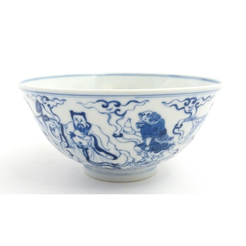 43 - A Chinese blue and white bowl decorated with the Eight Immortals. Character marks under. Approx. 3