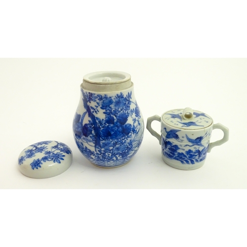 49 - A Chinese blue and white twin handled cup and cover decorated with cranes in flight with bamboo fini... 
