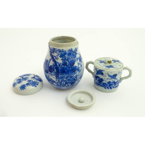 49 - A Chinese blue and white twin handled cup and cover decorated with cranes in flight with bamboo fini... 