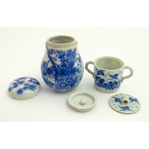 49 - A Chinese blue and white twin handled cup and cover decorated with cranes in flight with bamboo fini... 