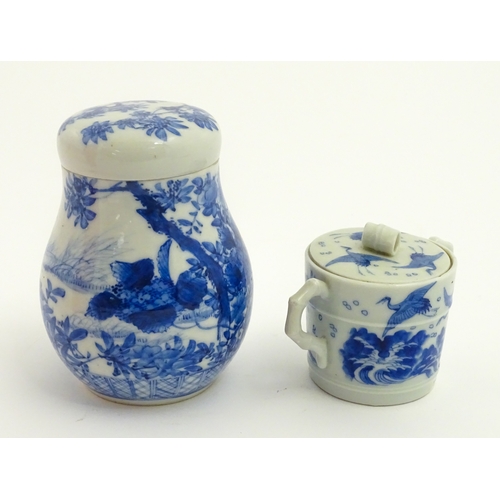 49 - A Chinese blue and white twin handled cup and cover decorated with cranes in flight with bamboo fini... 