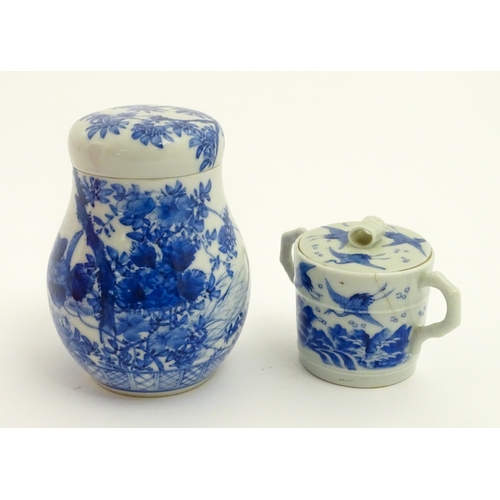 49 - A Chinese blue and white twin handled cup and cover decorated with cranes in flight with bamboo fini... 