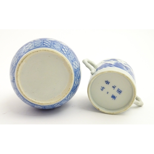 49 - A Chinese blue and white twin handled cup and cover decorated with cranes in flight with bamboo fini... 
