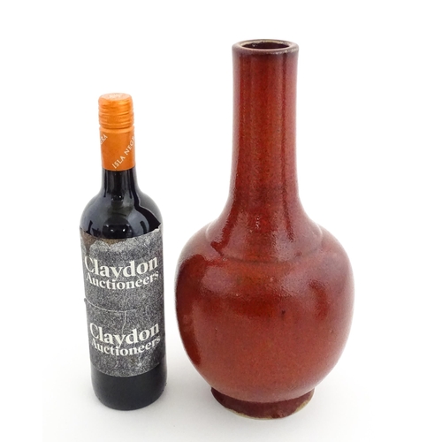 53 - A Chinese bottle vase with red sang de boeuf style glaze. Approx. 13 1/2