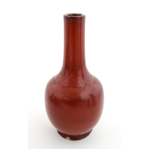 53 - A Chinese bottle vase with red sang de boeuf style glaze. Approx. 13 1/2