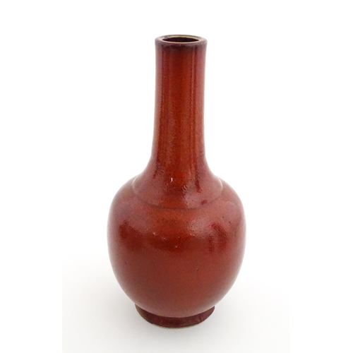 53 - A Chinese bottle vase with red sang de boeuf style glaze. Approx. 13 1/2