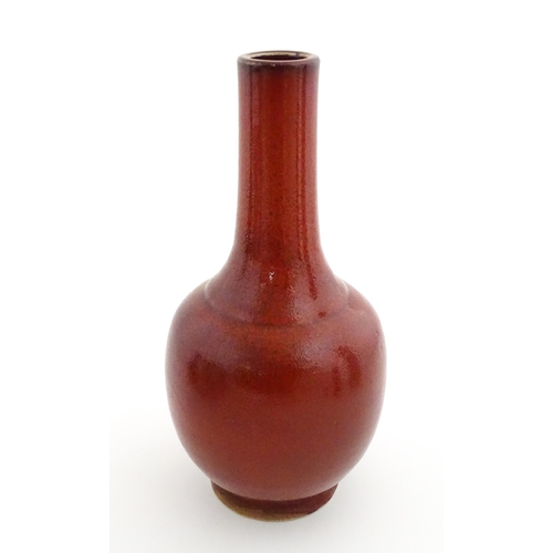 53 - A Chinese bottle vase with red sang de boeuf style glaze. Approx. 13 1/2