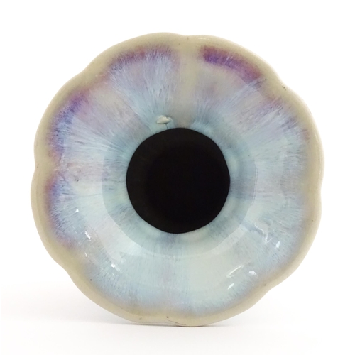 61 - A Chinese high fired twin handled vase of lobed form. Character marks under. Approx. 8 1/4