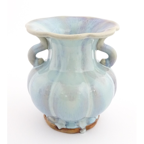 61 - A Chinese high fired twin handled vase of lobed form. Character marks under. Approx. 8 1/4