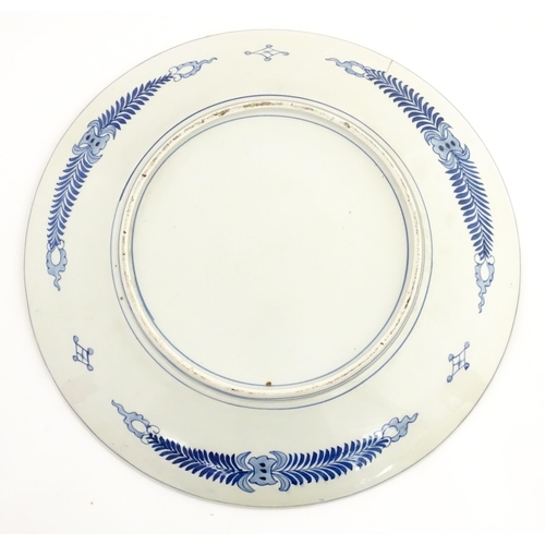 63A - A large Chinese blue and white charger decorated with prunus blossom and taihu rocks, with brushwork... 