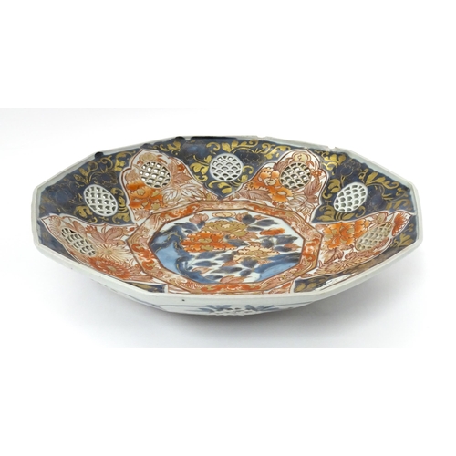 65A - A Japanese dish with ten sides decorated in the Imari palette with flowers and foliage, and ten roun... 
