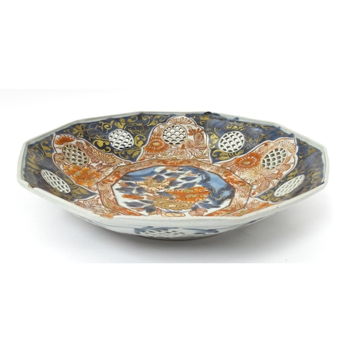 65A - A Japanese dish with ten sides decorated in the Imari palette with flowers and foliage, and ten roun... 