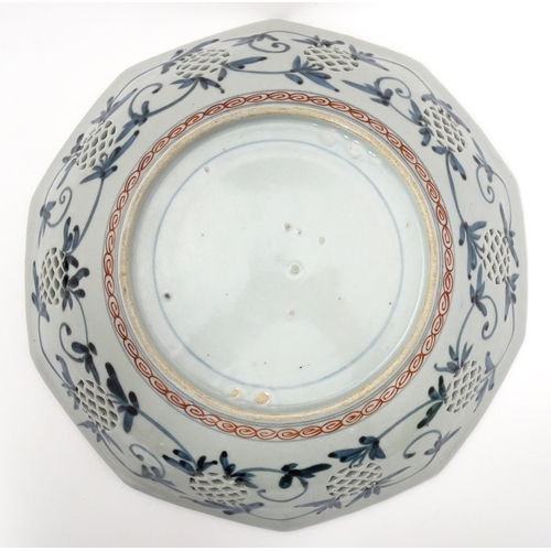 65A - A Japanese dish with ten sides decorated in the Imari palette with flowers and foliage, and ten roun... 