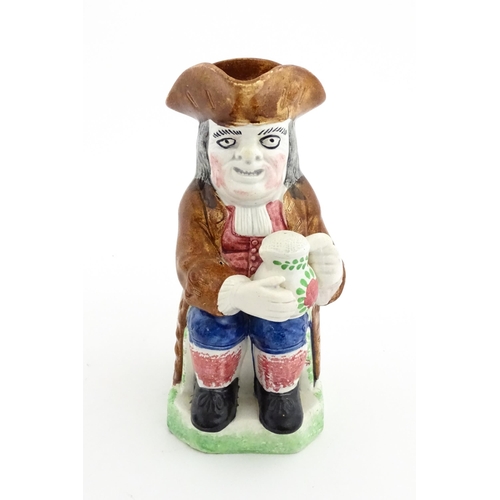 70 - A Staffordshire pottery Toby jug. Approx. 9 1/4