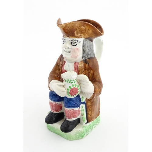 70 - A Staffordshire pottery Toby jug. Approx. 9 1/4