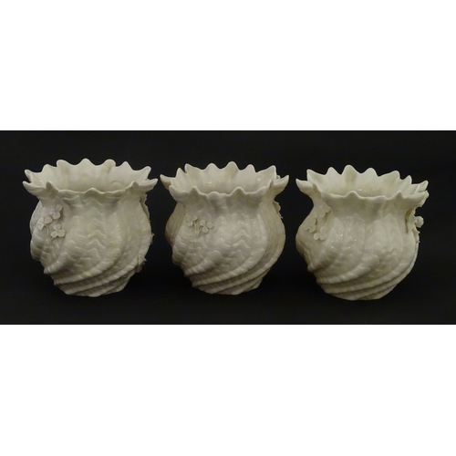 80 - Three small Belleek Neptune vases / jardinieres with applied flower and foliage decoration. Each bea... 