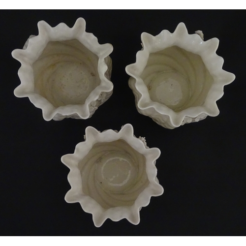 80 - Three small Belleek Neptune vases / jardinieres with applied flower and foliage decoration. Each bea... 
