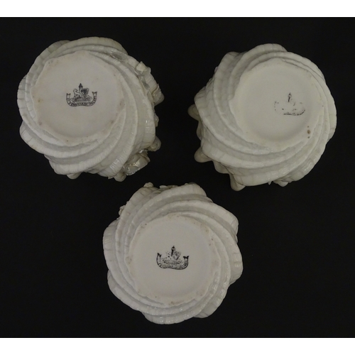 80 - Three small Belleek Neptune vases / jardinieres with applied flower and foliage decoration. Each bea... 